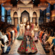 DALL·E 2024 01 13 19.19.47 A glamorous fashion show in Dubai featuring Manish Malhotras designs. The runway is set in a luxurious venue with an opulent backdrop. Models are wal